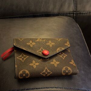 Louis Vuitton style wallet with red accents